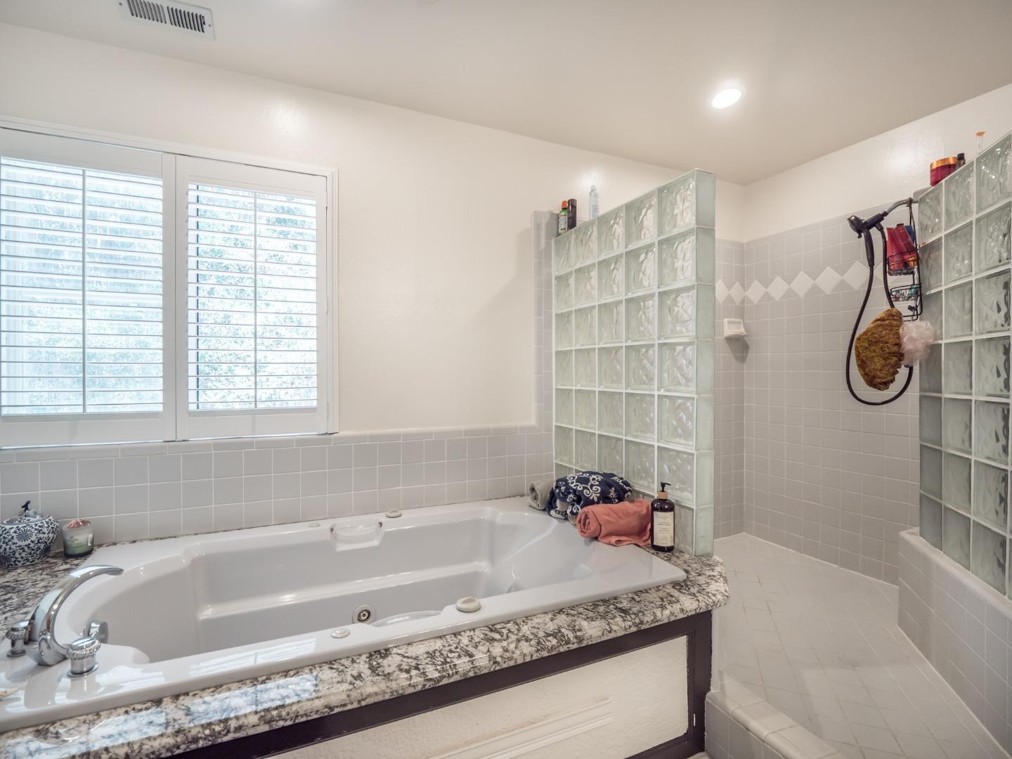 2185 Hames Road Aptos, CA 95003 - Photo 55 of 88 a bathroom with a granite countertop tub a sink and a window