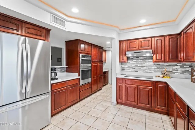 a kitchen with stainless steel appliances granite countertop a stove and a sink