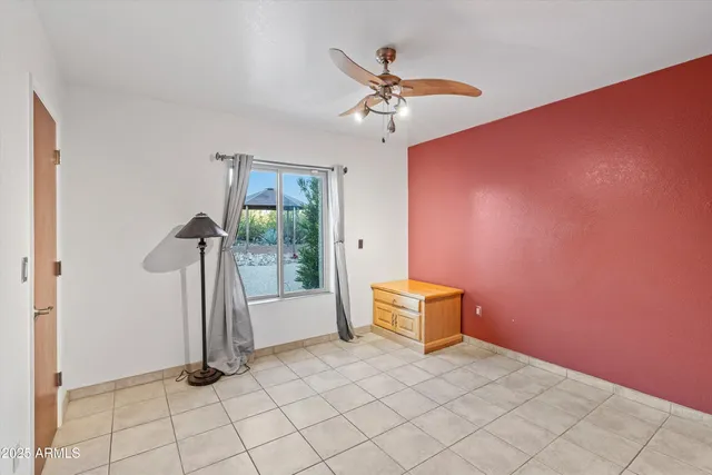 a view of a hallway with a ceiling fan