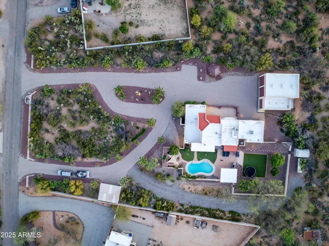an aerial view of a house a yard and a fountain