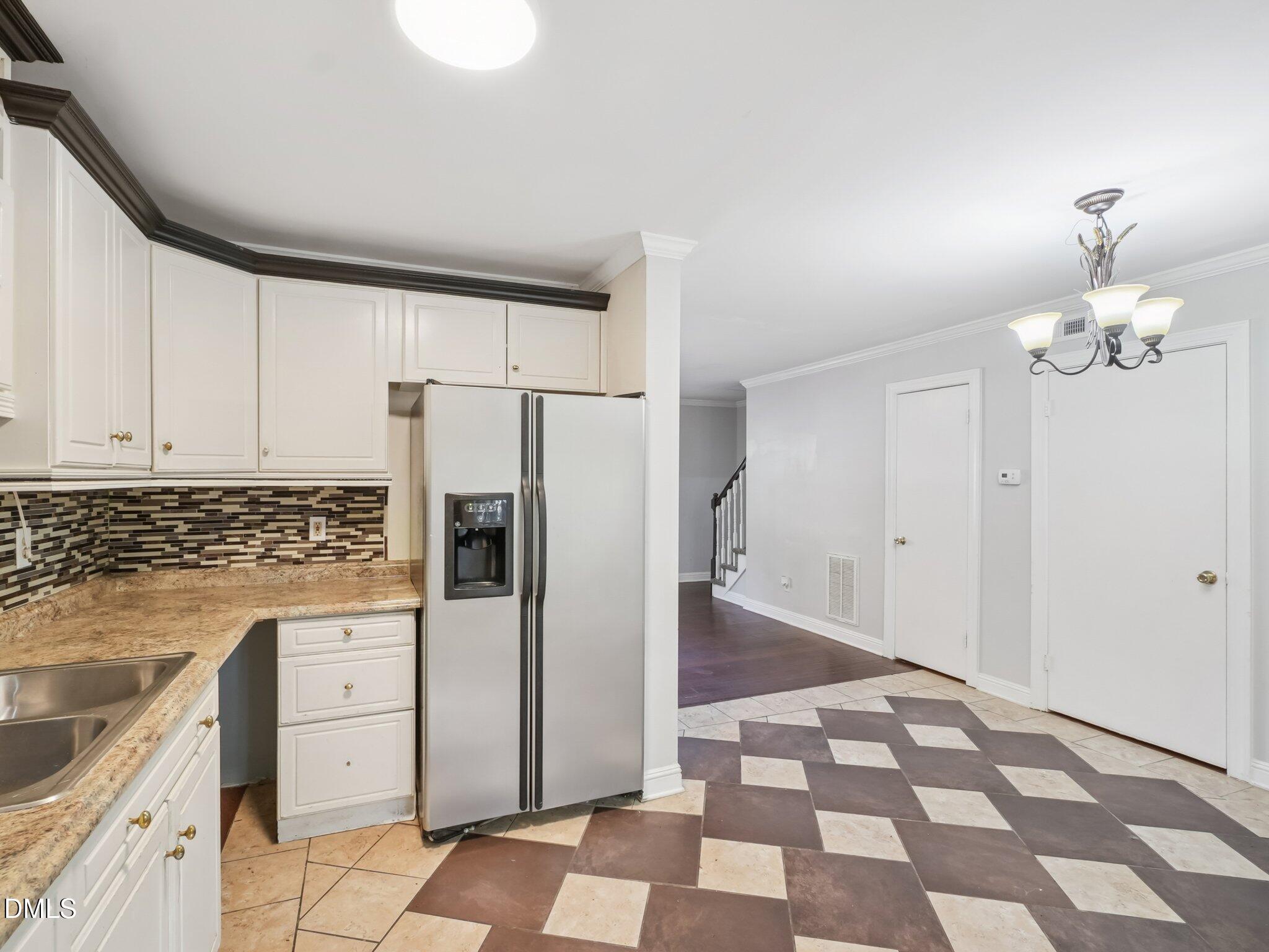 2146 Charles Street, Unit 37 Durham, NC 27707 - Photo 12 of 24 a kitchen with a refrigerator sink and cabinets