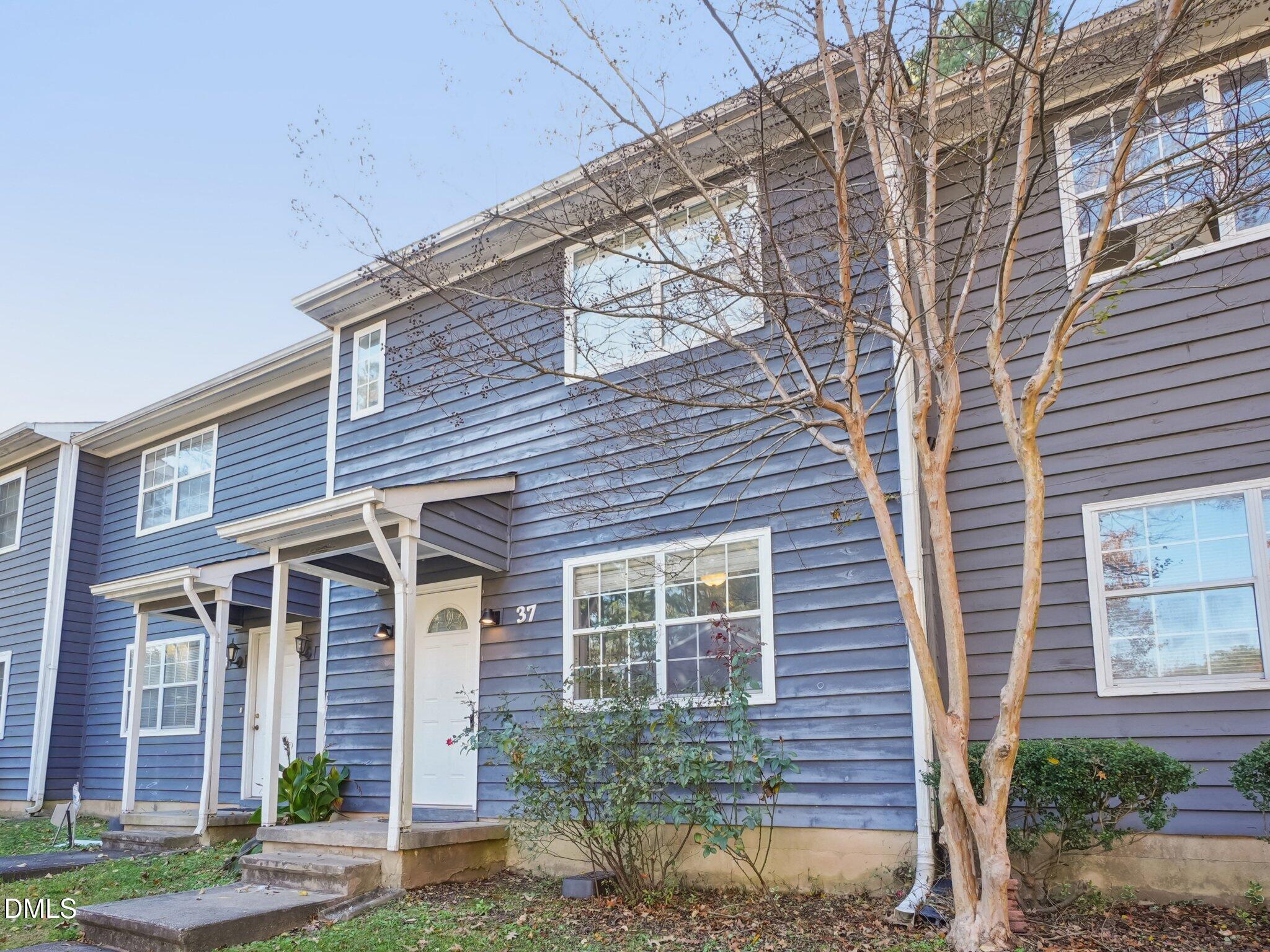 2146 Charles Street, Unit 37 Durham, NC 27707 - Photo 2 of 24 a front view of a house with a yard and potted plants