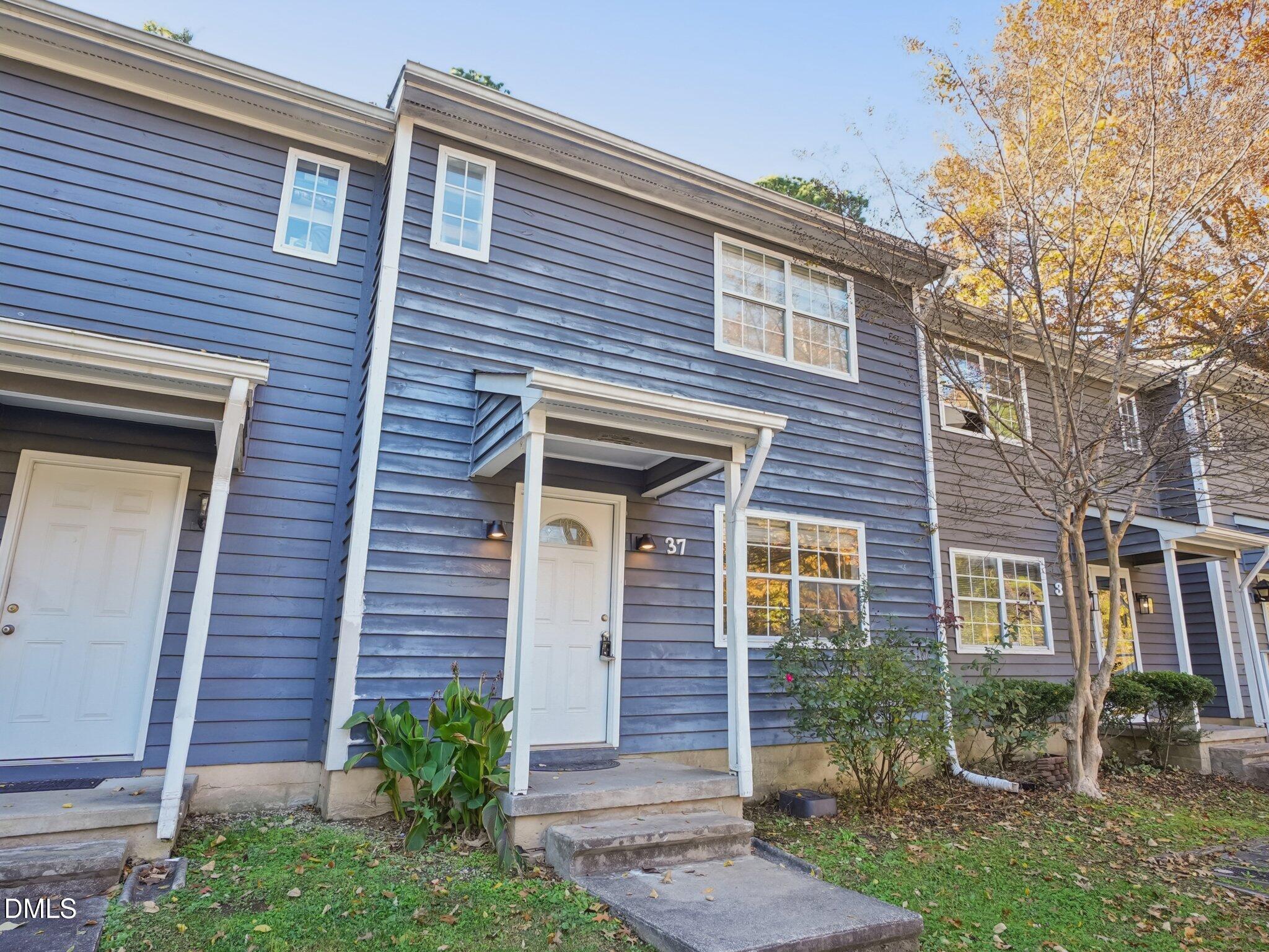 2146 Charles Street, Unit 37 Durham, NC 27707 - Photo 3 of 24 a view of brick house with large windows and a table and chairs