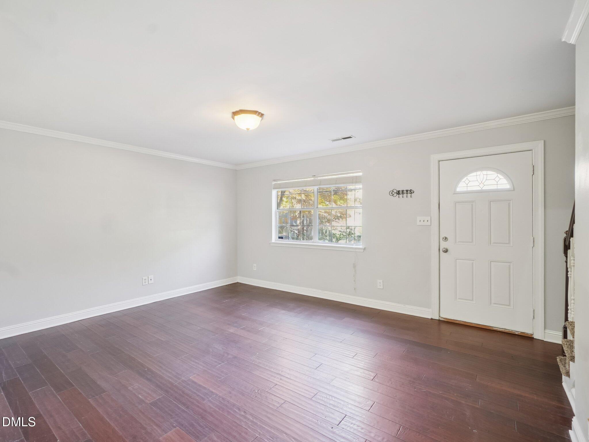 2146 Charles Street, Unit 37 Durham, NC 27707 - Photo 6 of 24 an empty room with wooden floor and windows