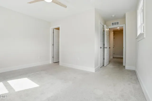 an empty room with a bathroom and a sink