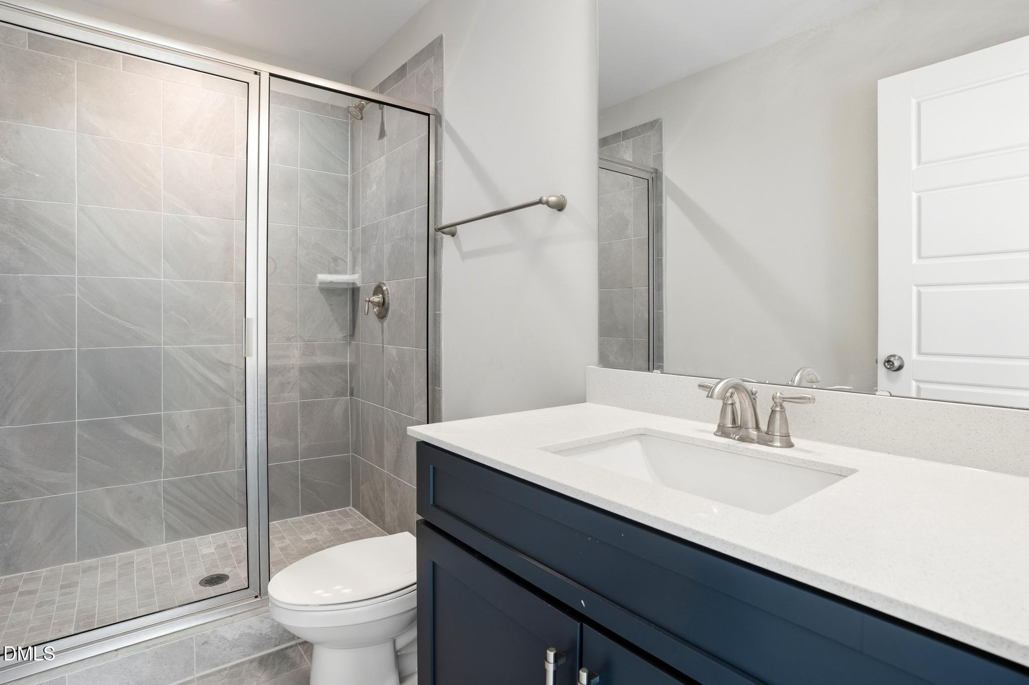 551 Homeland Avenue Durham, NC 27707 - Photo 16 of 32 a bathroom with a sink a toilet and shower