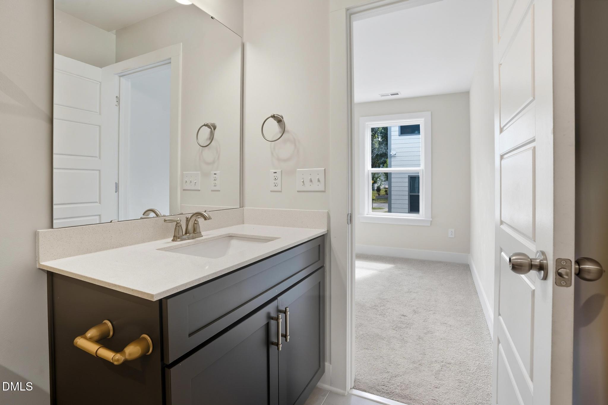 551 Homeland Avenue Durham, NC 27707 - Photo 17 of 32 a bathroom with a sink and a mirror