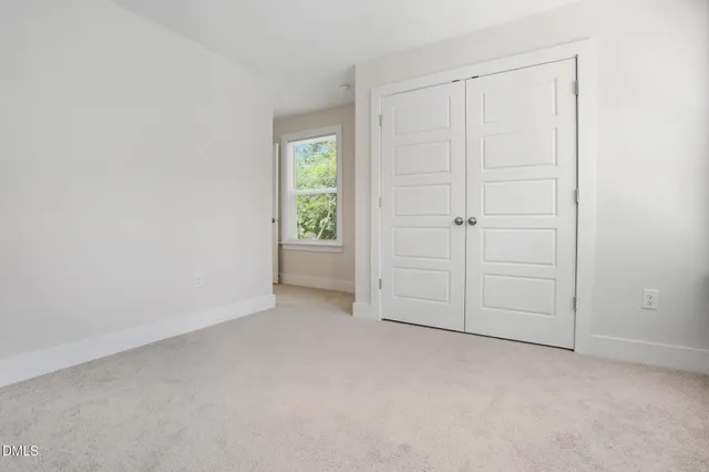 an empty room with closet area