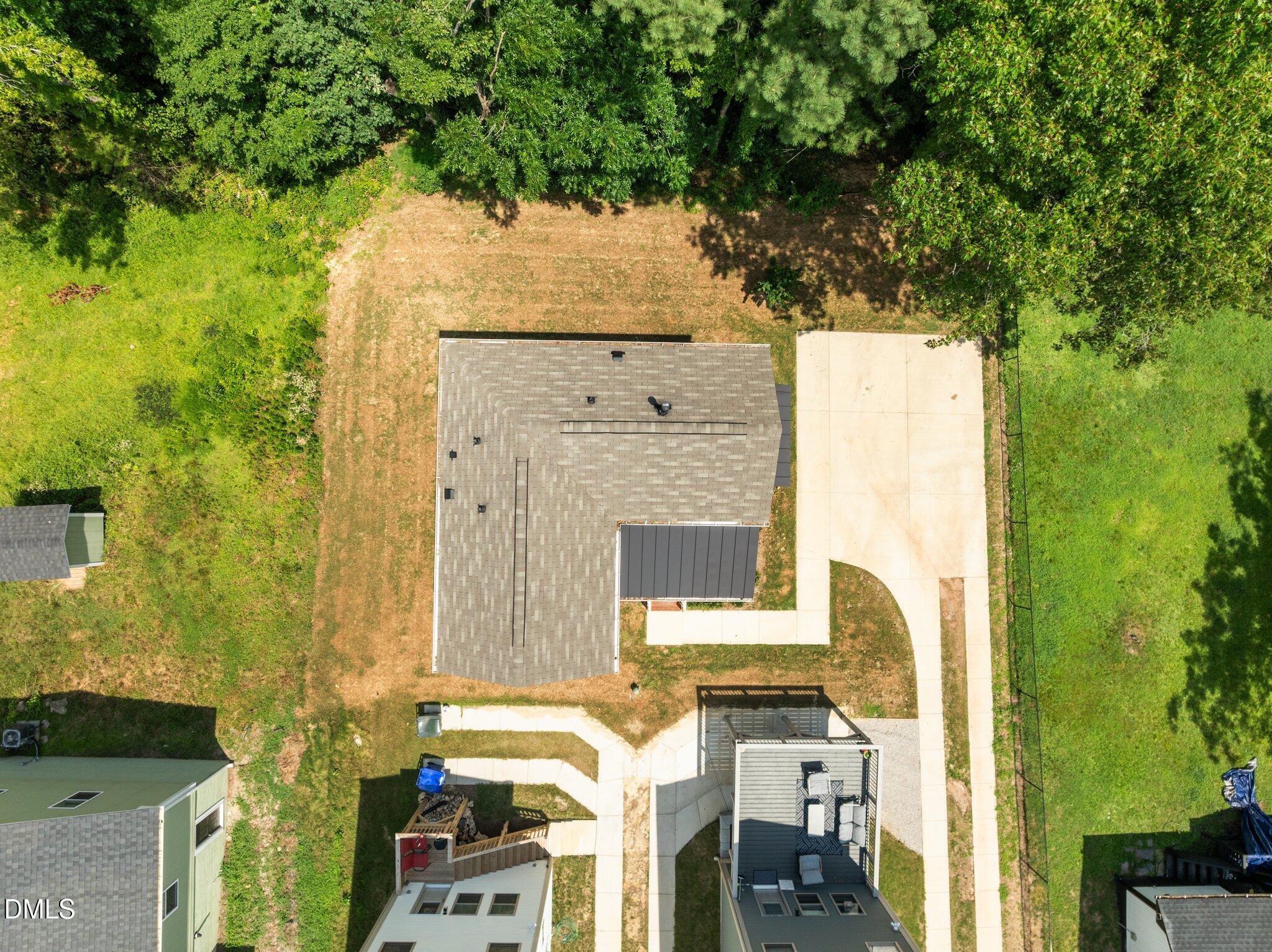 551 Homeland Avenue Durham, NC 27707 - Photo 26 of 32 an aerial view of a house with outdoor space and trees all around