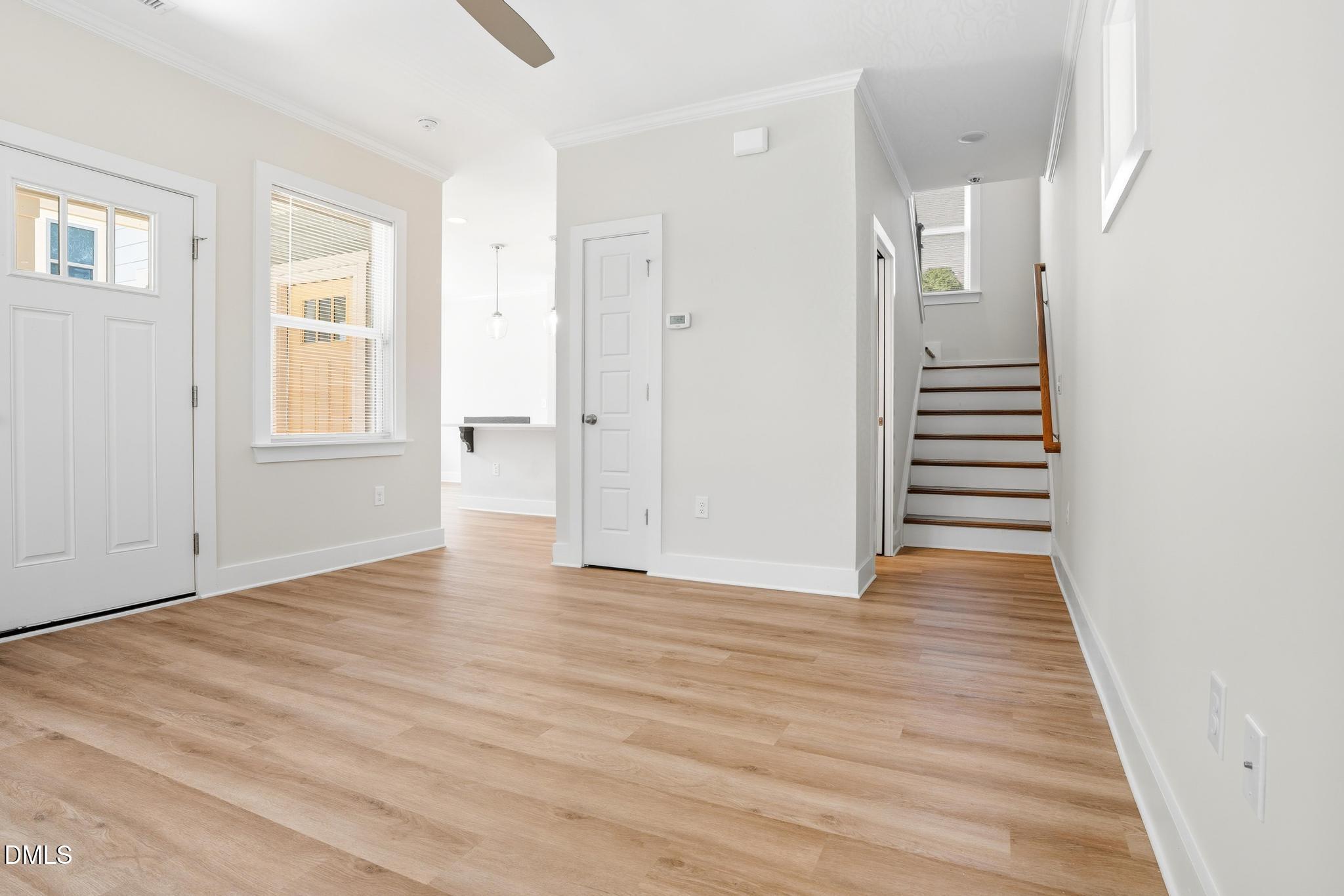 551 Homeland Avenue Durham, NC 27707 - Photo 4 of 32 a view of an empty room with wooden floor and entryway
