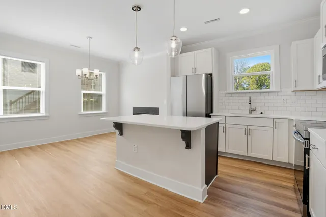 a kitchen with stainless steel appliances sink stove and refrigerator