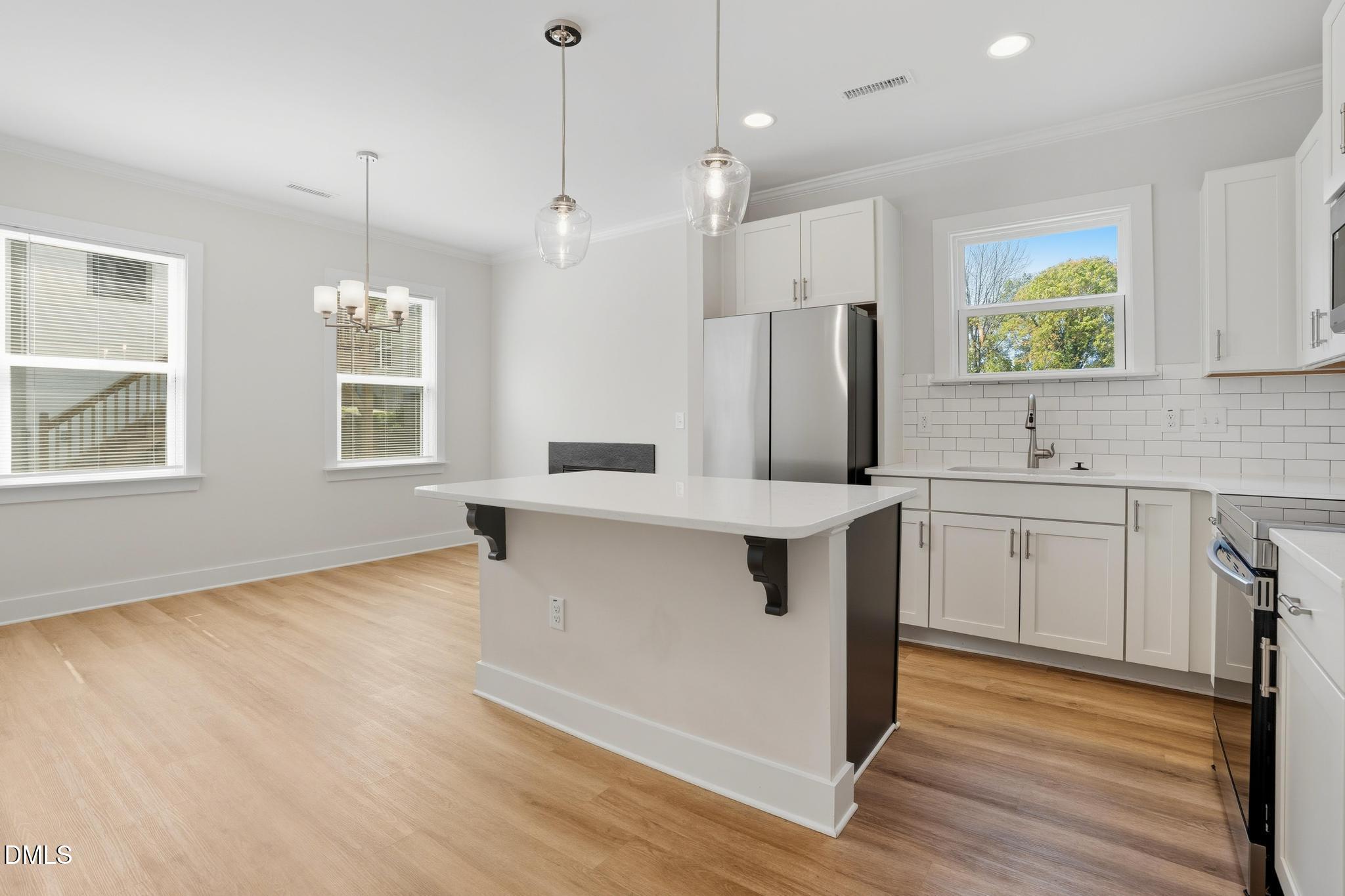 551 Homeland Avenue Durham, NC 27707 - Photo 5 of 32 a kitchen with stainless steel appliances sink stove and refrigerator