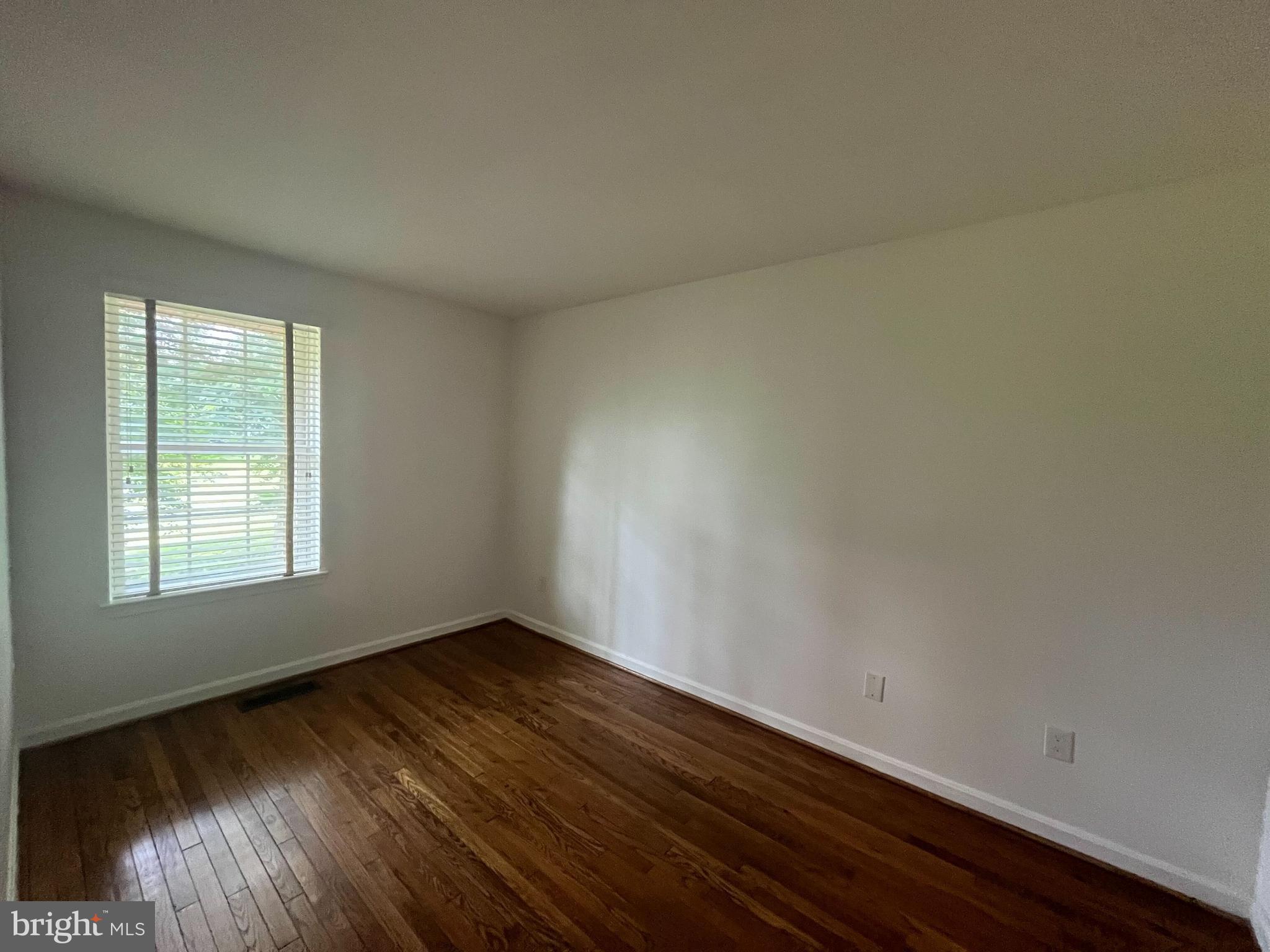 2080 Golf Course Drive Reston, VA 20191 - Photo 12 of 17 an empty room with wooden floor and windows