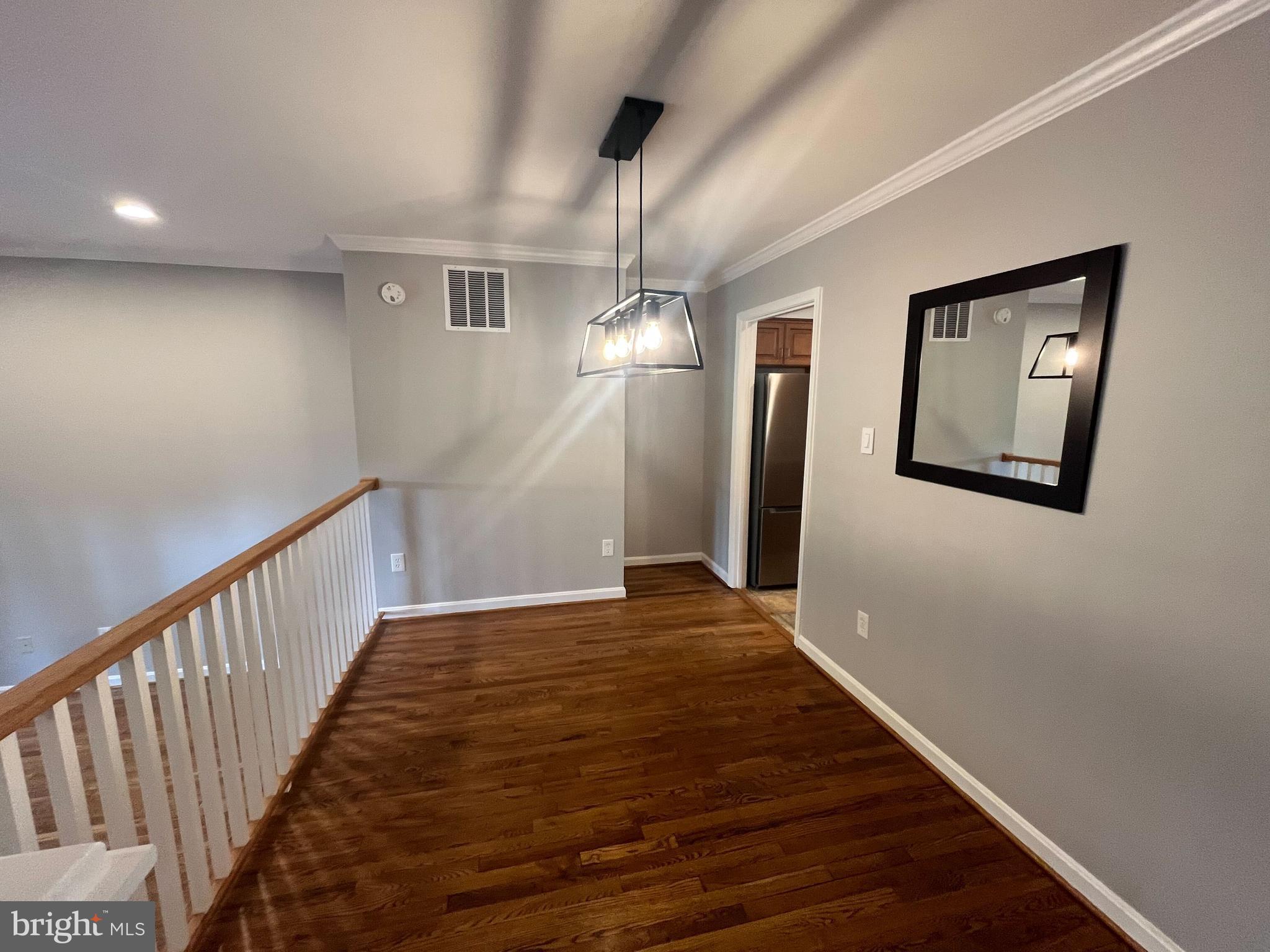 2080 Golf Course Drive Reston, VA 20191 - Photo 5 of 17 a view of a livingroom with wooden floor and stairs