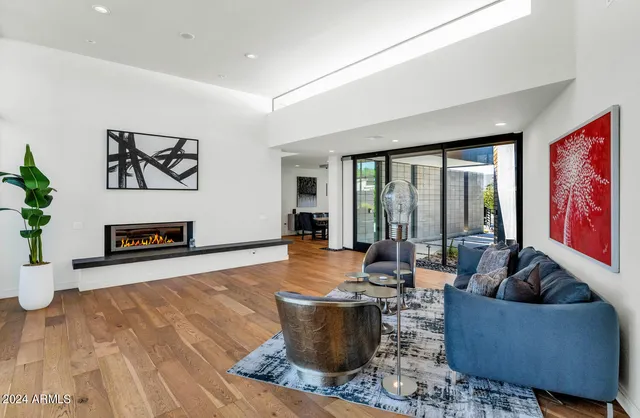 a living room with furniture and a floor to ceiling window