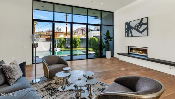 a living room with furniture large window and flat screen tv