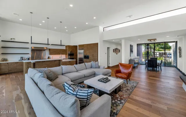 a large kitchen with sink a counter top space and stainless steel appliances