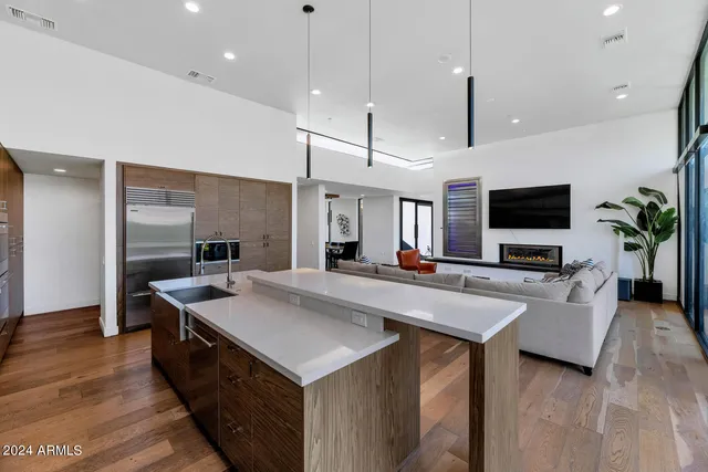 a large kitchen with stainless steel appliances a large counter top