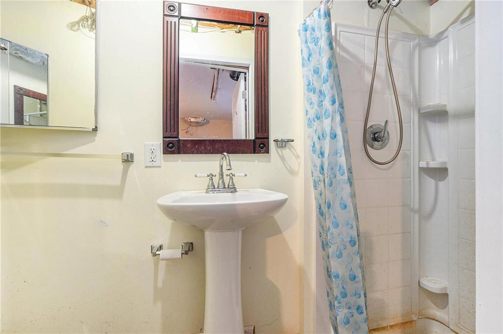 2358 Cannon Hill Road Southwest Lilburn, GA 30047 - Photo 11 of 22 a bathroom with a sink a toilet and shower