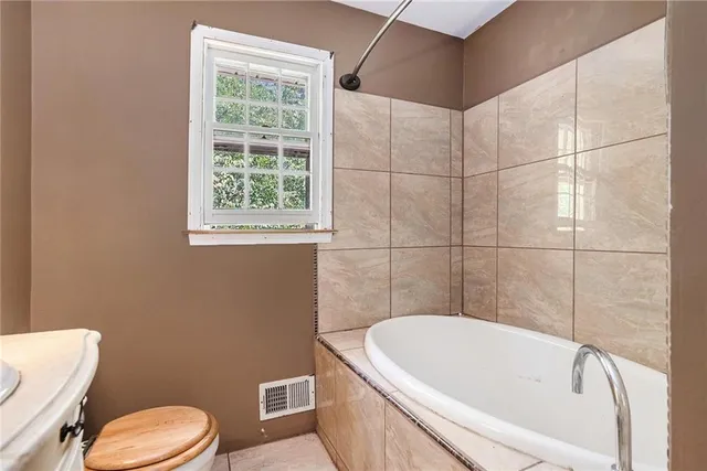 an empty room with a window and a ceiling fan