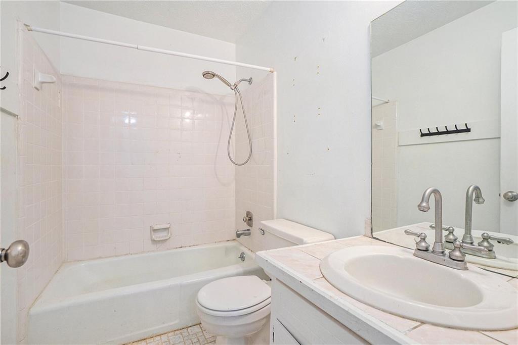 2358 Cannon Hill Road Southwest Lilburn, GA 30047 - Photo 19 of 22 a bathroom with a sink toilet and shower