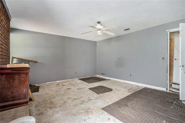 a kitchen that has a lot of white cabinets a sink and appliances