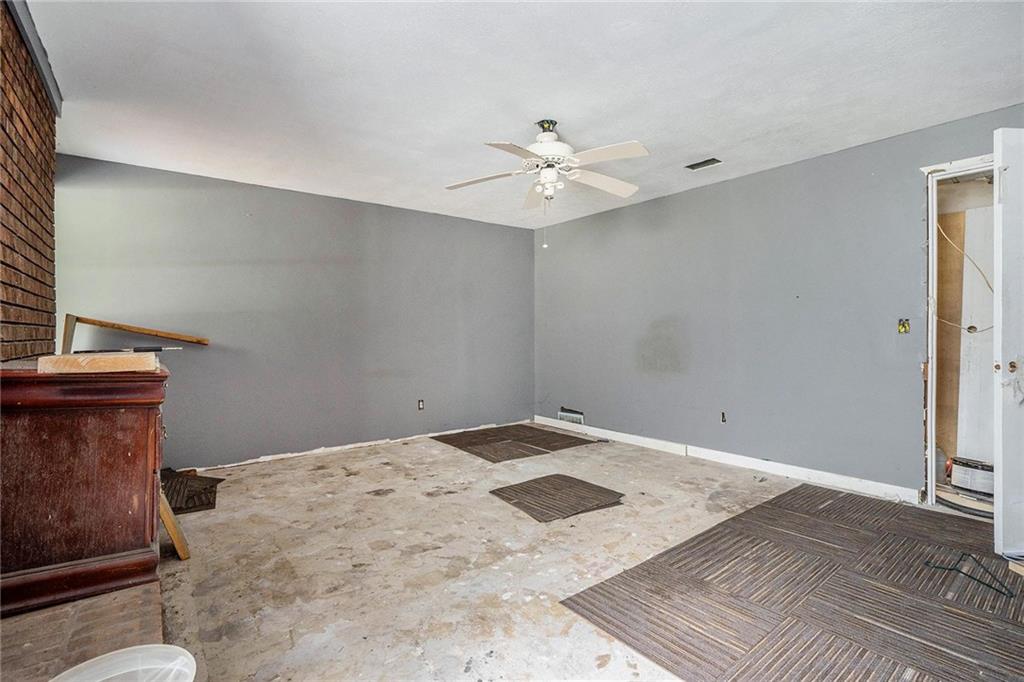 2358 Cannon Hill Road Southwest Lilburn, GA 30047 - Photo 20 of 22 a view of a room with a ceiling fan and wooden floor