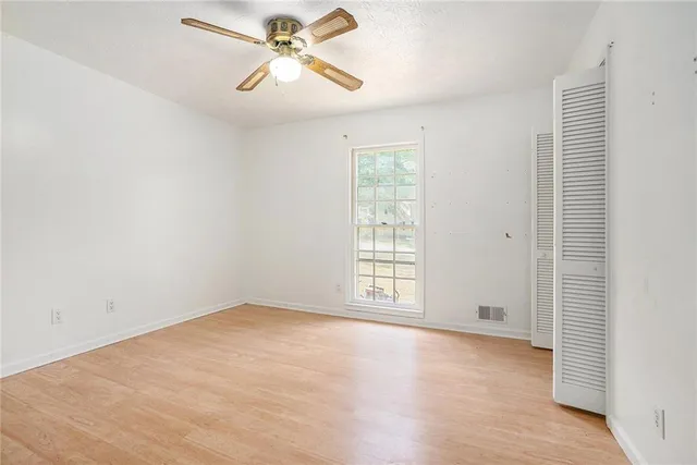 wooden floor in an empty room with a window