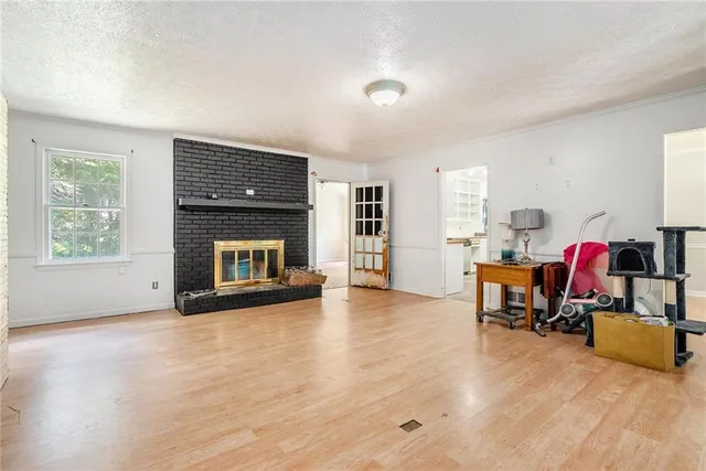 a view of a livingroom with a fireplace and workspace