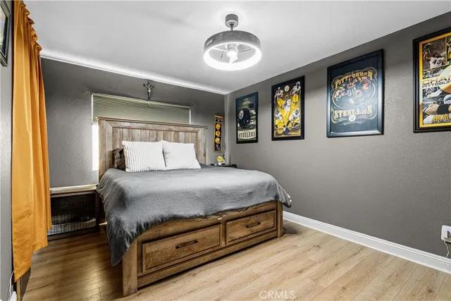 a bedroom with a bed and wooden floor