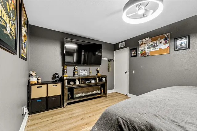 a bedroom with a bed and a television