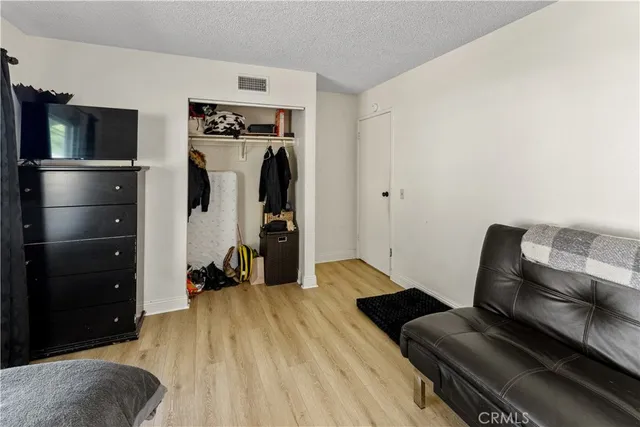 a bedroom with a bed and a television