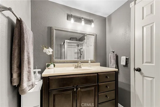 a bathroom with a sink vanity and a mirror