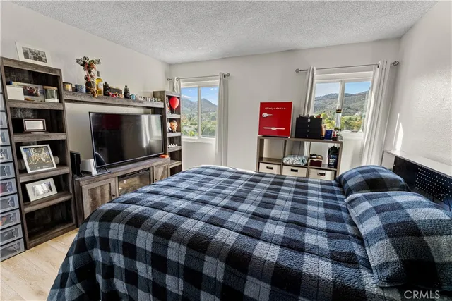 a bedroom with a bed and a flat screen tv