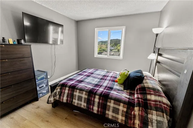 a bedroom with a bed and a flat screen tv