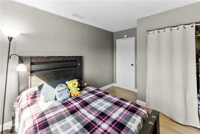 a bedroom with a bed and a dresser