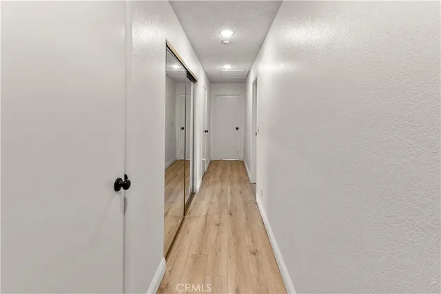 a view of a hallway with wooden floor