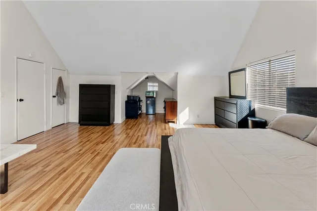 a bed room with a bed and a television