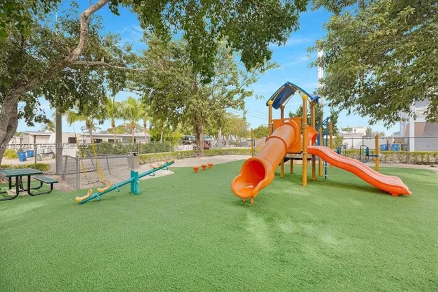 a view of playground with a slide and swing