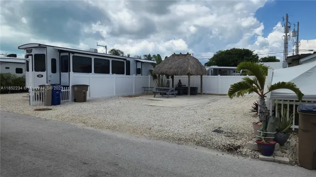 a view of a house with patio next to a yard