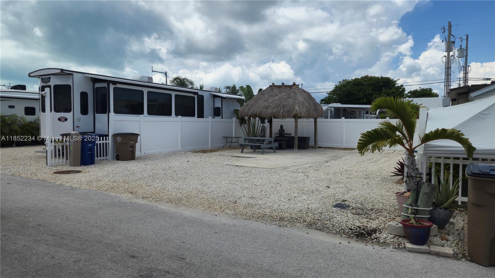 325 Calusa Street Key Largo, FL 33037 - Photo 4 of 23 a view of a house with patio next to a yard