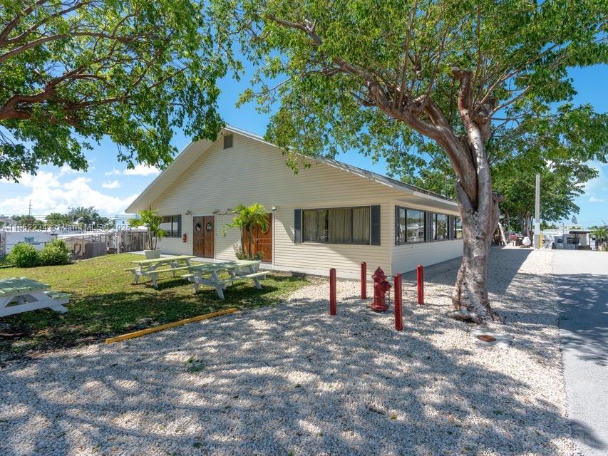 325 Calusa Street Key Largo, FL 33037 - Photo 10 of 23 a view of a house with backyard and sitting area