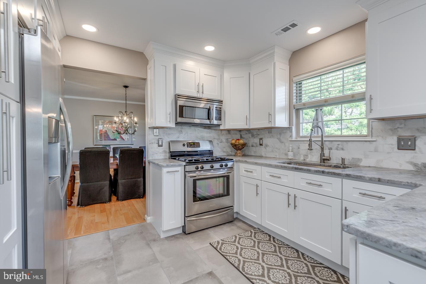 11 Pavilion Road Voorhees, NJ 08043 - Photo 11 of 43 a kitchen with stainless steel appliances granite countertop a stove top oven a sink and a refrigerator