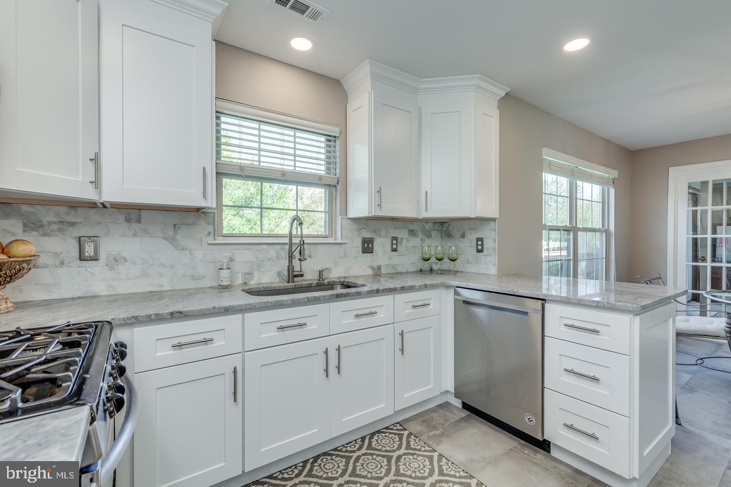 11 Pavilion Road Voorhees, NJ 08043 - Photo 13 of 43 a kitchen with granite countertop white cabinets white appliances sink and window