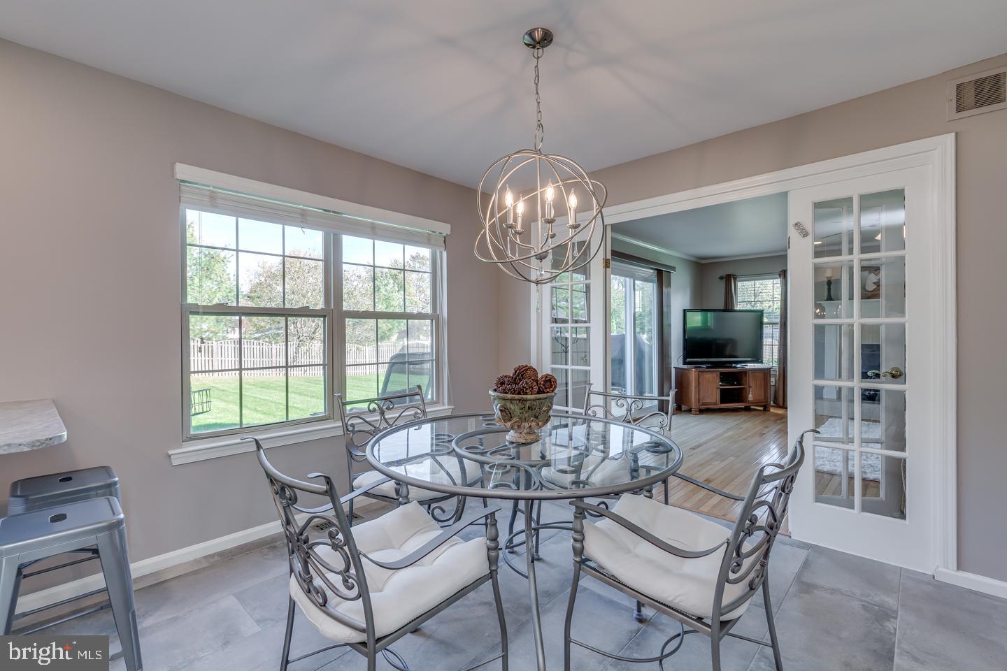 11 Pavilion Road Voorhees, NJ 08043 - Photo 15 of 43 a dining room with furniture a chandelier and wooden floor