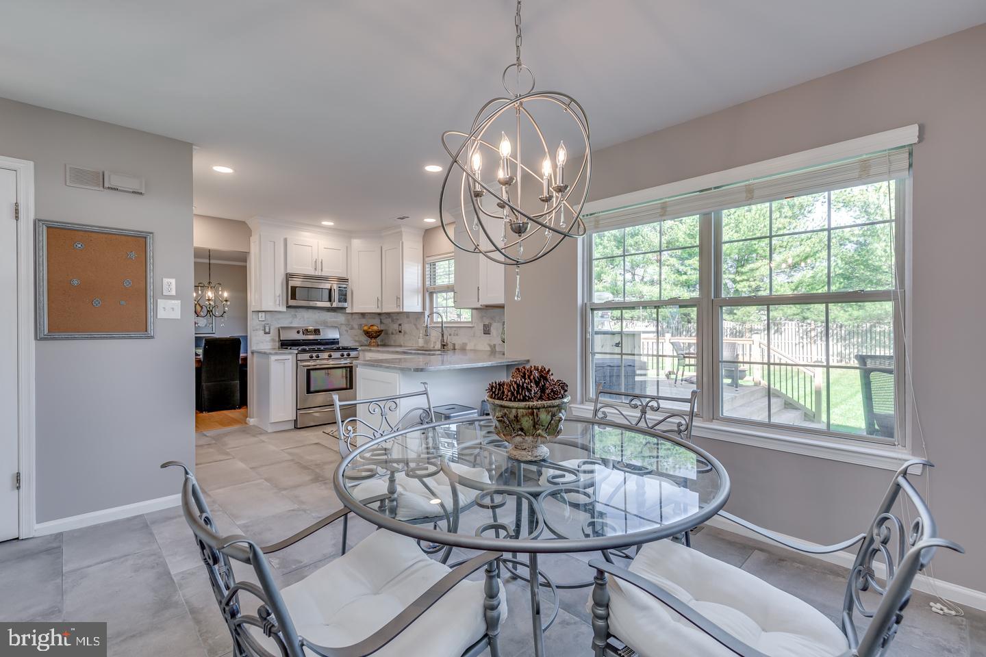11 Pavilion Road Voorhees, NJ 08043 - Photo 16 of 43 a dining room with kitchen island stainless steel appliances granite countertop furniture and kitchen view
