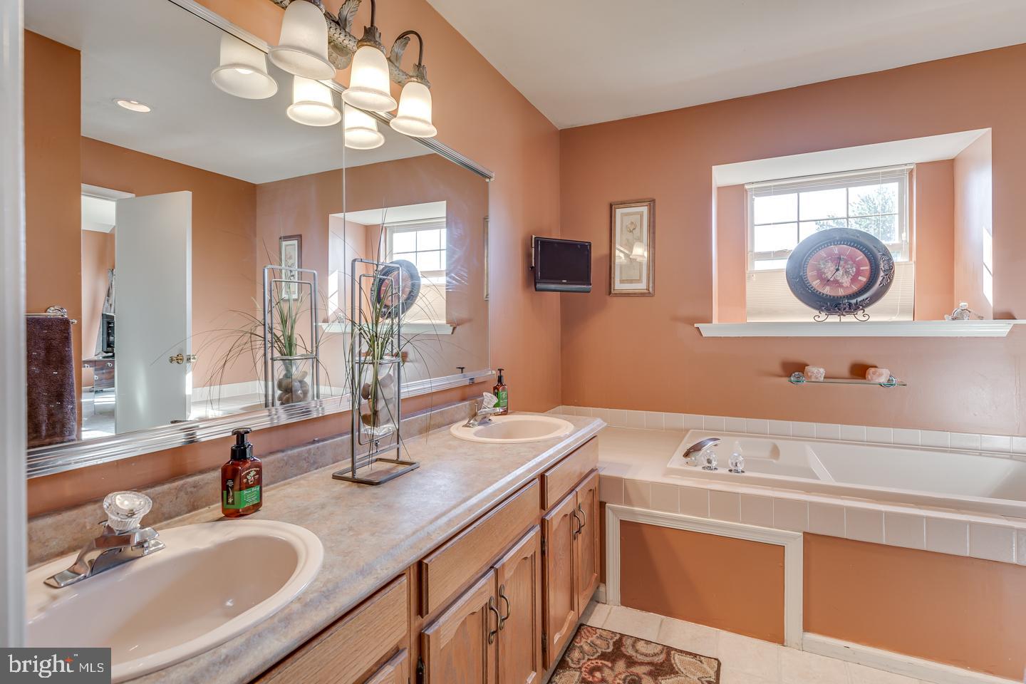 11 Pavilion Road Voorhees, NJ 08043 - Photo 29 of 43 a bathroom with a sink a stove and a mirror