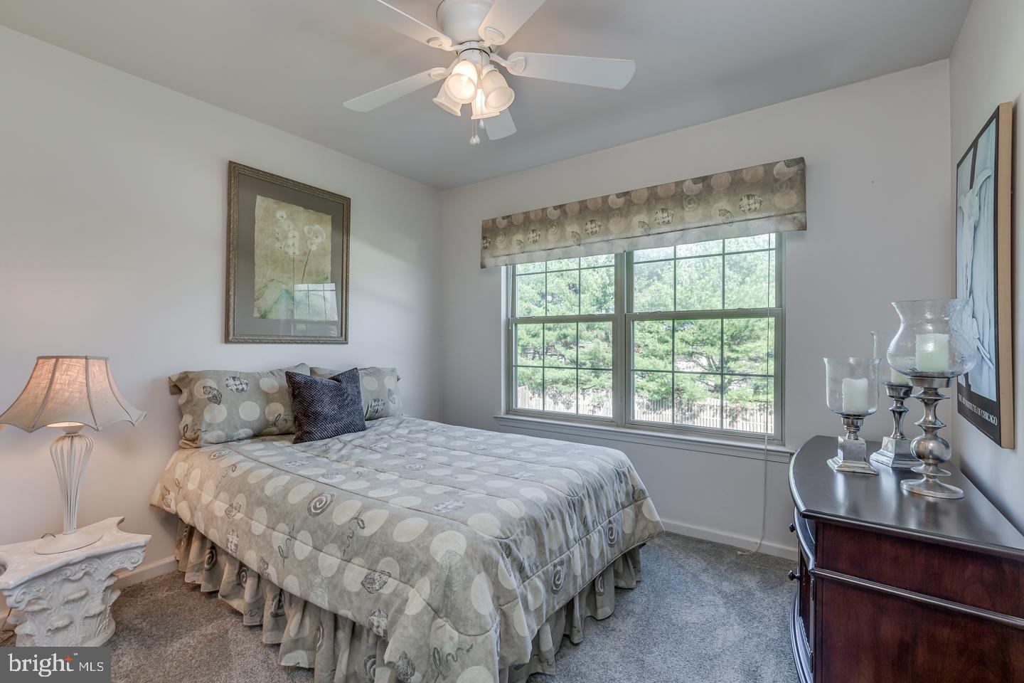 11 Pavilion Road Voorhees, NJ 08043 - Photo 34 of 43 a bedroom with a bed and a table in it