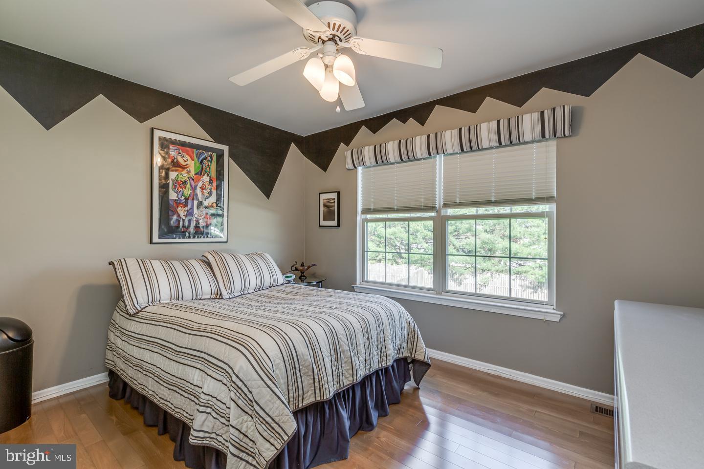 11 Pavilion Road Voorhees, NJ 08043 - Photo 36 of 43 a bedroom with a large bed and a chandelier