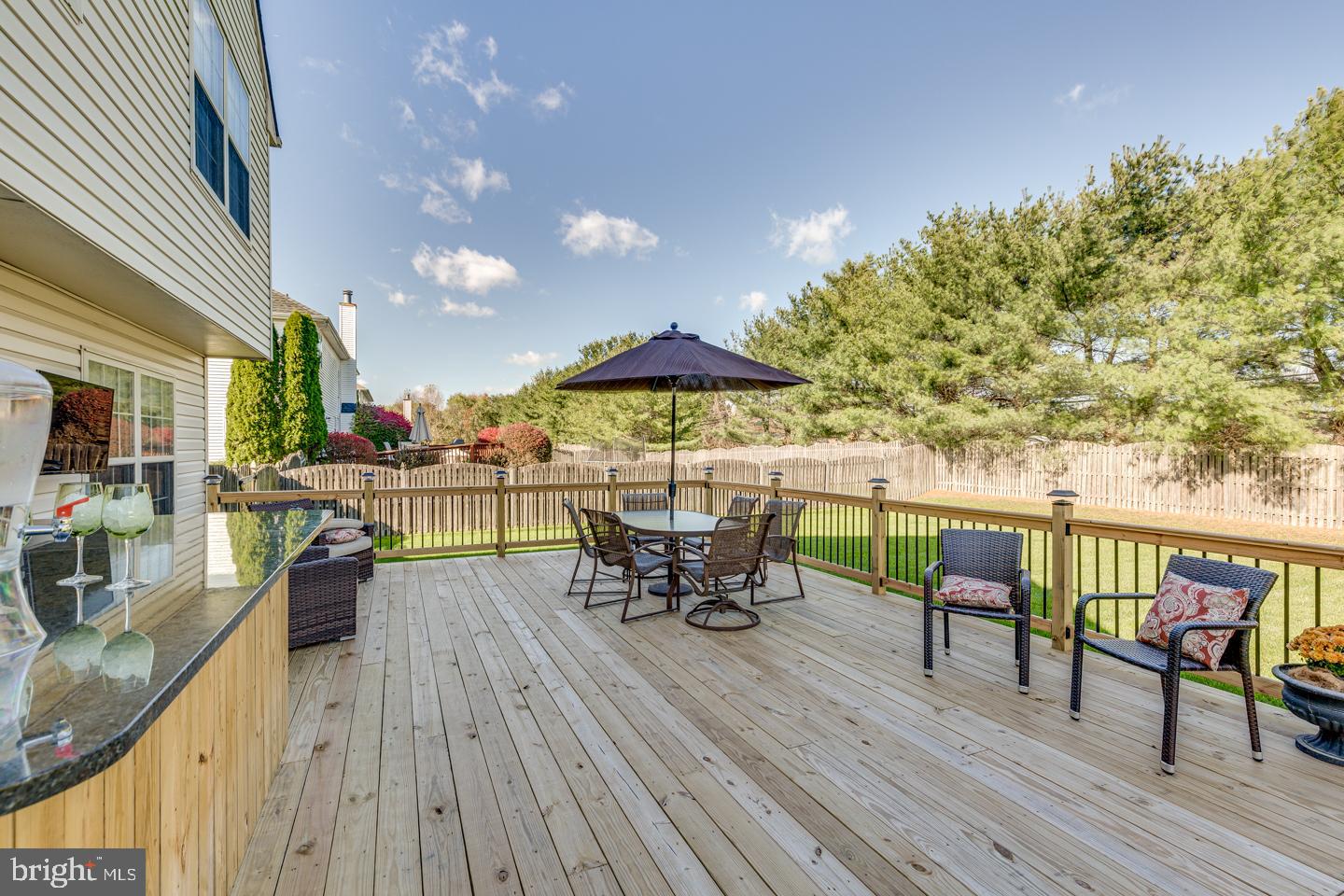 11 Pavilion Road Voorhees, NJ 08043 - Photo 39 of 43 a view of a roof deck with table and chairs under an umbrella with wooden floor